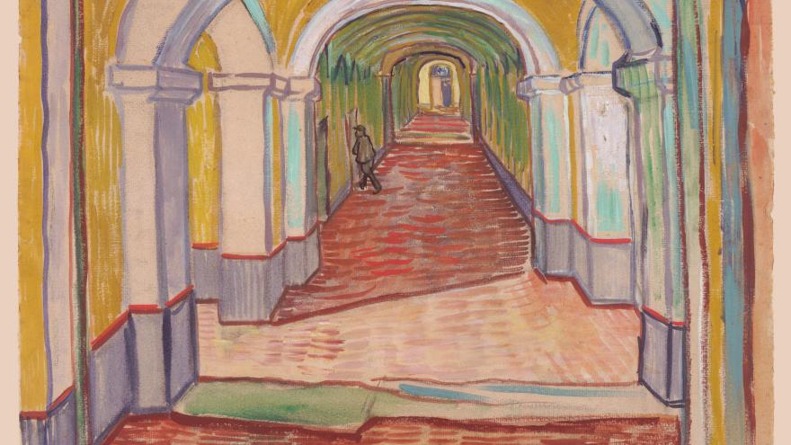 Long arched corridor with a lone figure