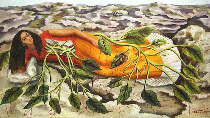 Woman lying on the earth, entwined by roots