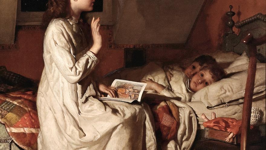 Girl sitting on bed, reading to two children under covers