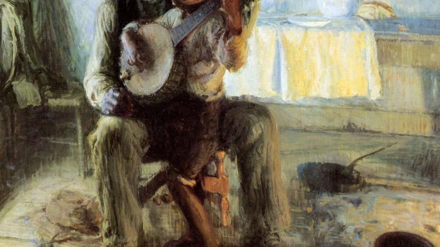 boy sitting on man's lap with banjo